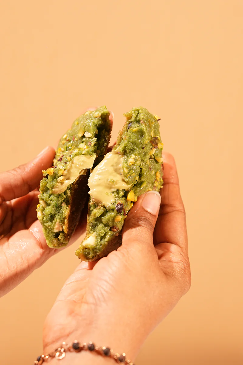 A pistachio cookie broken in half