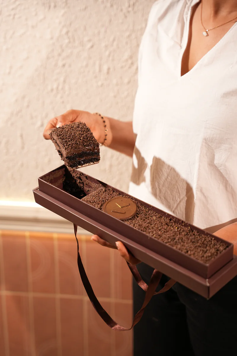 A Maybac chocolate box held open