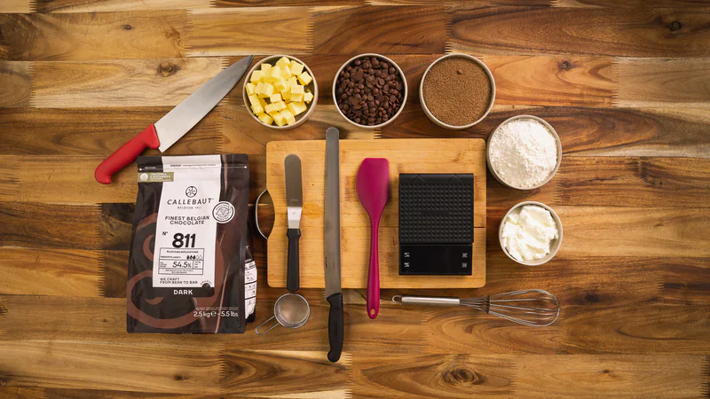Callebaut chocolate and pastry tools laid out on a wooden table